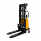Electric pallet stacker with long forks and vertical lifting mast, yellow motor housing visible on the side.