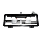 Industrial linear actuator assembly mounted in a black frame, featuring silver actuator blocks and hydraulic/pneumatic fittings.