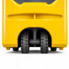 Close-up of the underside of a yellow industrial vehicle, showing two large black wheels