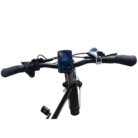Electric bike handlebars with a blue digital display showing speed and gear, plus grips and brake levers on both sides.