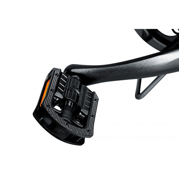 Clipless bicycle pedal with a locking mechanism and orange accent attached to a black crank arm edge.