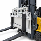 Close-up of forklift forks and hydraulic carriage assembly ready to lift pallets, showing metal frame and hoses.